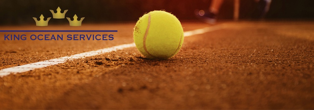 Tennis ball on a court with king ocean services logo